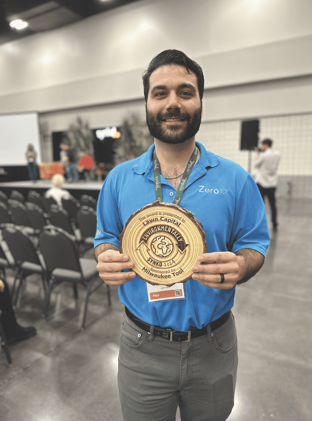 Naboth Diaz accepting the Environmentally SYNKD Award on behalf of the Lawn Capital team
